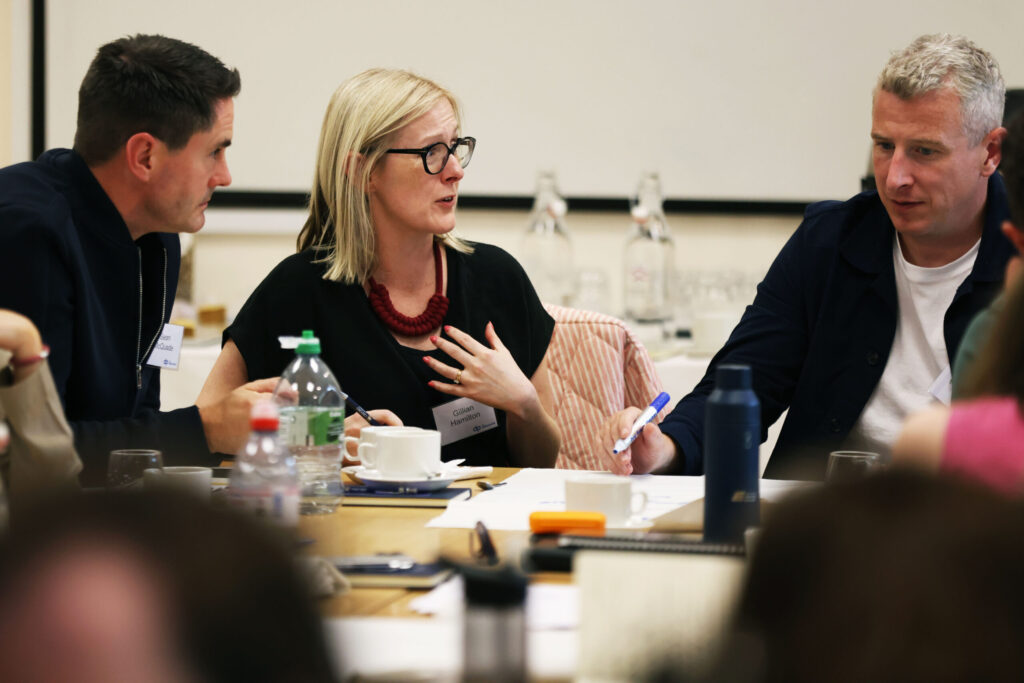 Fellows engage in conversation during a session.